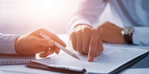 Two persons checking a document