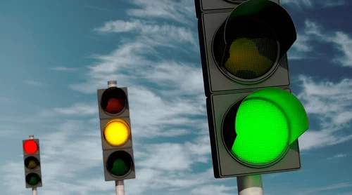 Three traffic lights each showing a different color