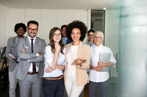 Several office workers smiling at the camera